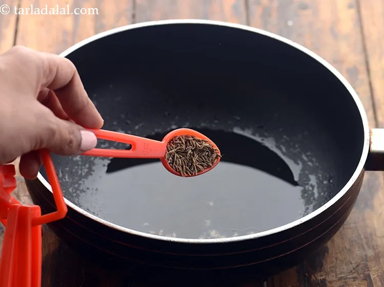 Step 4 – Once the oil is hot, add the cumin seeds.