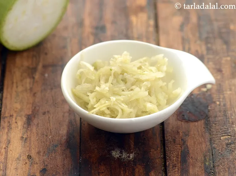 Step 25 – The add the vegetables. Add 1/2 cup&nbsp;<a href="https://www.tarladalal.com/glossary-grated-bottle-gourd-1048i">grated bottle gourd (doodhi / lauki)</a>.&nbsp;With extremely low …