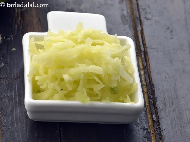 Step 5 – Grate the raw mangoes, we require 1 cup&nbsp;<a href="https://www.tarladalal.com/glossary-grated-raw-mango-2033i">grated raw mango</a>.