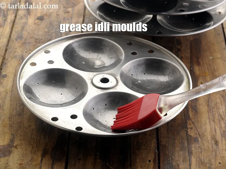 Step 33 – Grease idli moulds with ghee or oil.