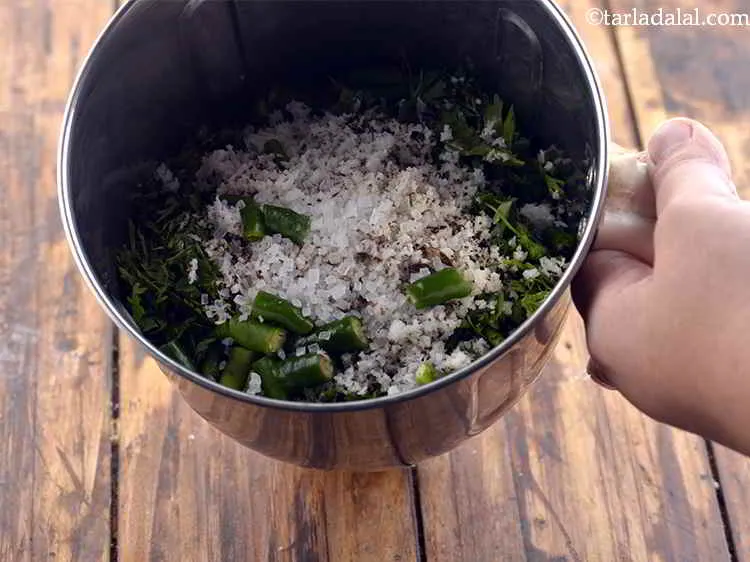 Step 10 – Add the sugar. It helps in balancing the sour flavor of hari chutney from lemon.