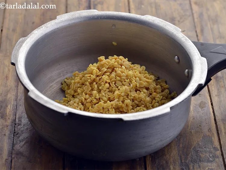 Step 19 – Take a pressure cooker, add the soaked dals.