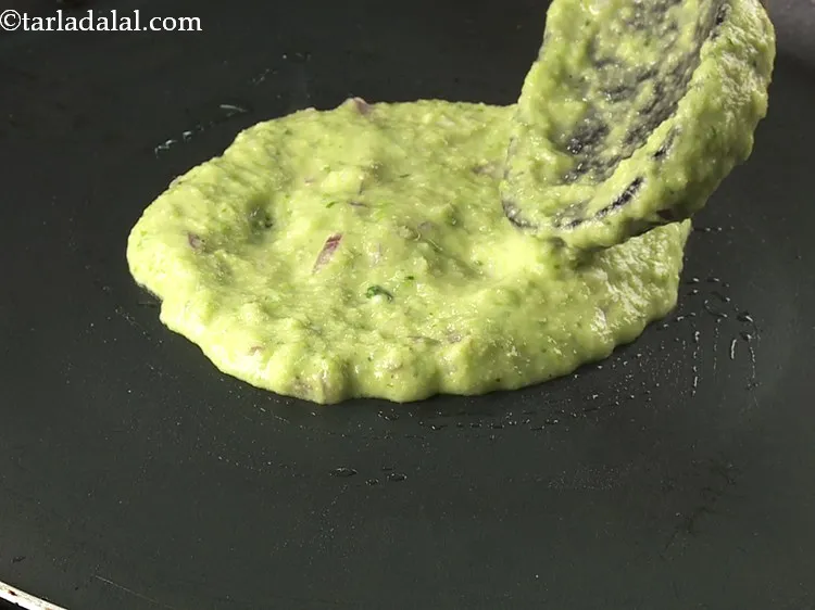 Step 14 – Pour a spoonful of the&nbsp;<strong>Green Peas Pancake&nbsp;</strong>batter on it.