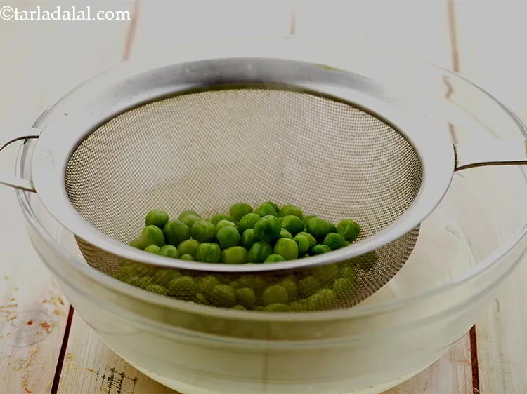 Step 7 – Strain the green peas using a strainer.