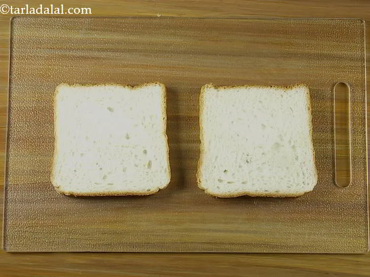 Step 12 – Place 2 bread slices on a clean, dry surface. <a href="https://www.tarladalal.com/Bread-Loaf-Basic-White-Bread-Loaf-Using-Yeast-2448r" target="_blank">Bread loaf</a> is easily …