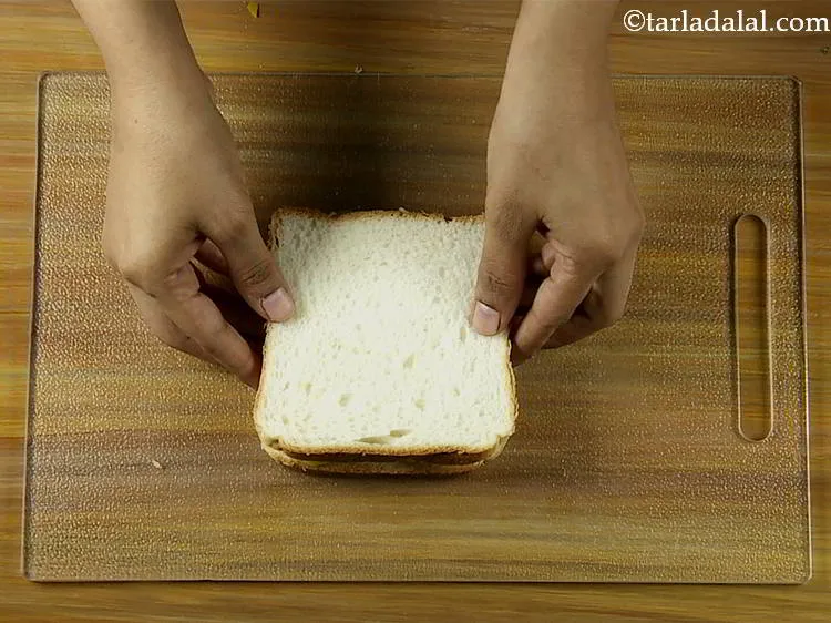 Step 15 – Sandwich it with another bread slice with the buttered side facing downwards.