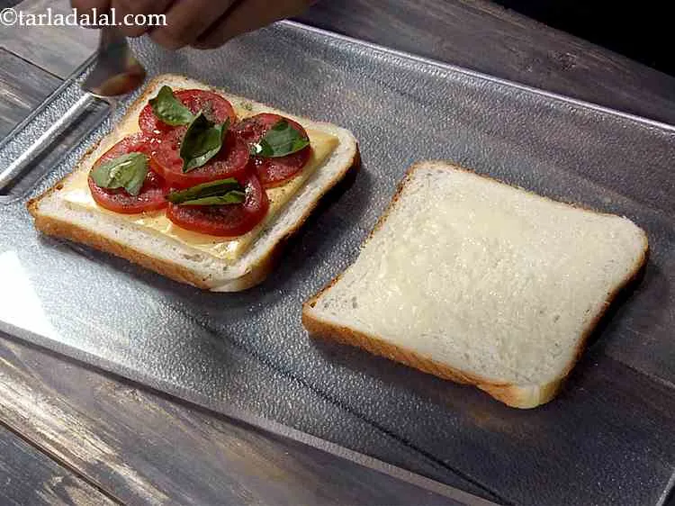 Step 8 – Now drizzle little olive oil over it. After all, this sandwich is a classic combination …