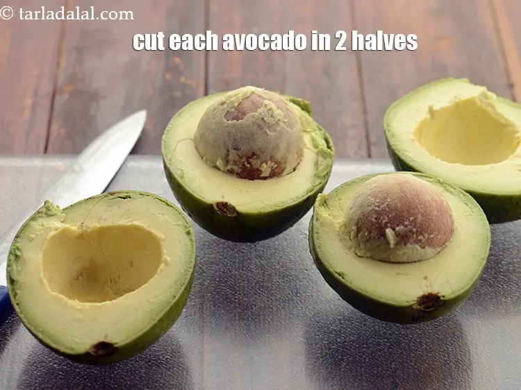 Step 4 – <meta charset="UTF-8" />Cut each avocado in 2 halves using a sharp knife.&nbsp;<br /> &nbsp;