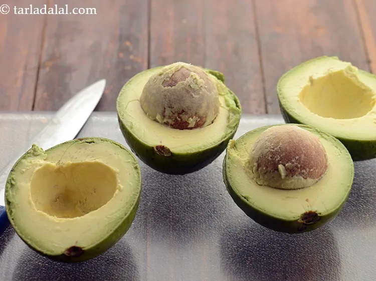 Step 88 – Cut each avocado in 2 halves using a sharp knife.