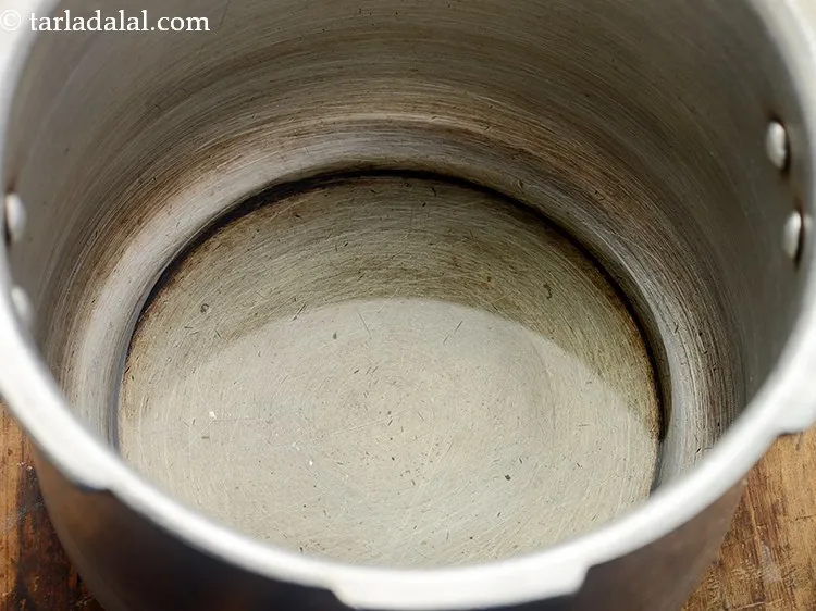 Step 5 – To temper <strong>Khari bhaat | Gujarati vagharelo bhaat</strong>, heat the ghee in a pressure cooker. …