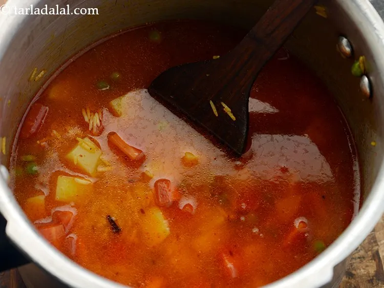 Step 20 – Mix well, so the veggies, masala and rice are uniformly mixed. For an added crunch, …