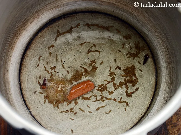 Step 9 – When the seeds crackle, add asafoetida.