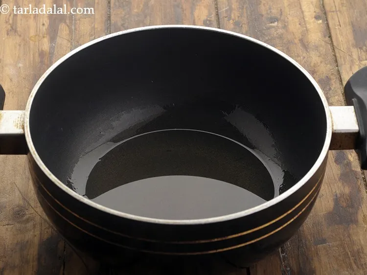 Step 2 – On a high flame heat oil in a deep pan till it smokes.