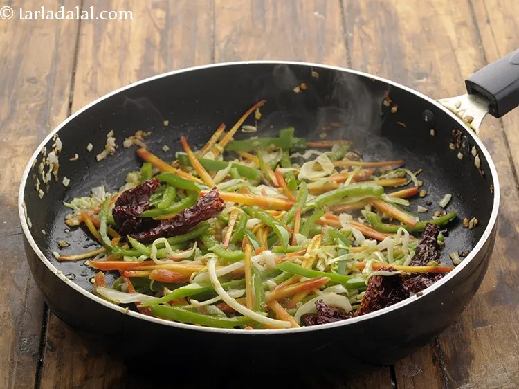 Step 11 – Now add the sliced capsicum. Saut? on a high flame for 1 to 2 minutes.