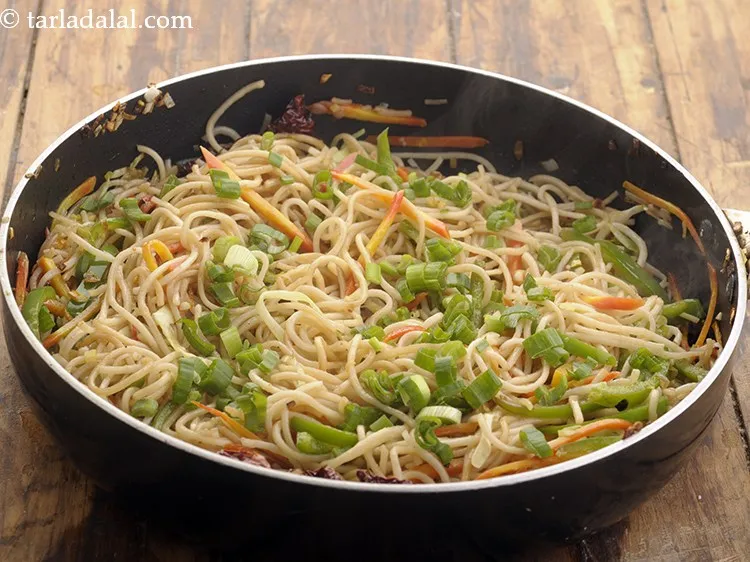 Step 18 – Finally sprinkle spring onion greens and toss&nbsp;<b><span style="font-size: 12pt; font-family: Cambria;">hakka noodles | Indo Chinese …