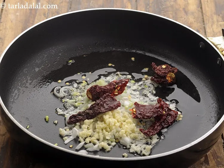 Step 8 – Then add the finely chopped garlic, broken red chillies and saut? on a high flame …