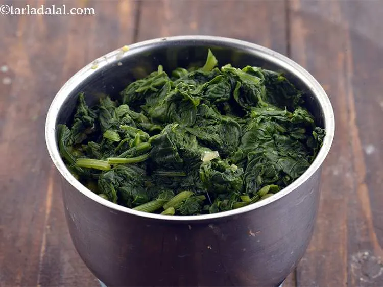 Step 16 – Add the blanched spinach. Before adding see that you squeeze out excess water from the …
