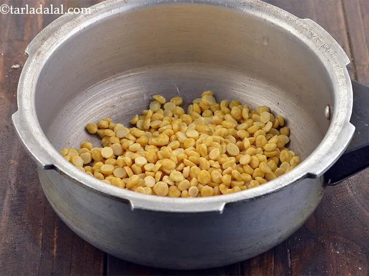 Step 7 – Add the chana dal to a pressure cooker.