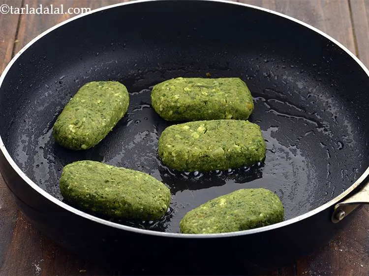 Step 18 – Heat &frac12; tsp oil in a broad non-stick pan and put 5 tikkis on it …