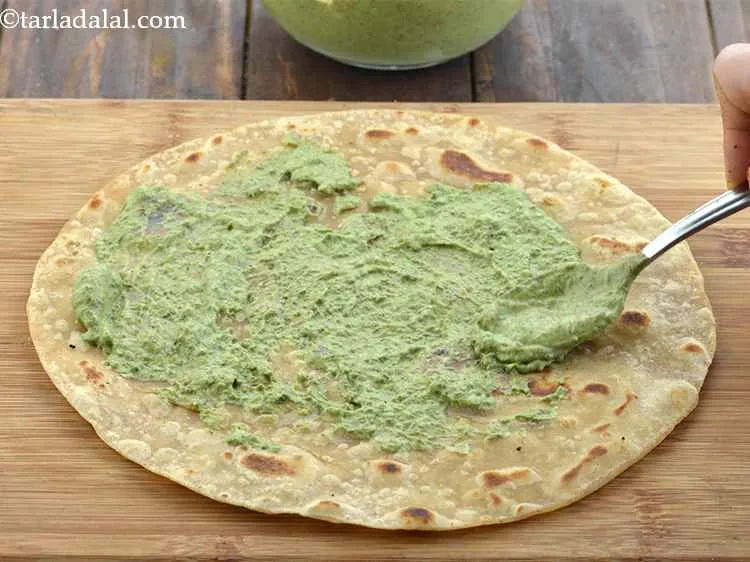 Step 38 – Place a roti on a clean dry surfacand take 2-3 tbsps of the Pahadi spread …