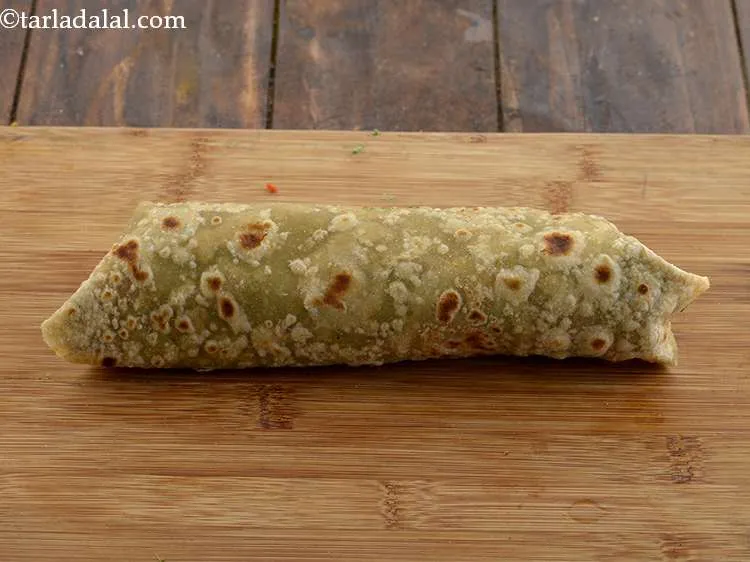 Step 43 – To make the roll, fold over the top and the bottom halves of the roti. …