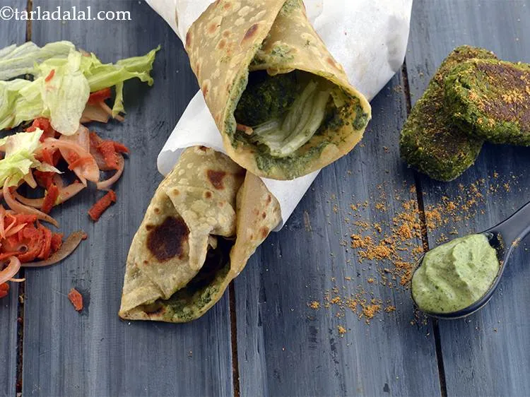 Step 44 – Cover the bottom half of the&nbsp;<strong>Hara Bhara Tikkis roll</strong>&nbsp;with butter paper or aluminium foil and …