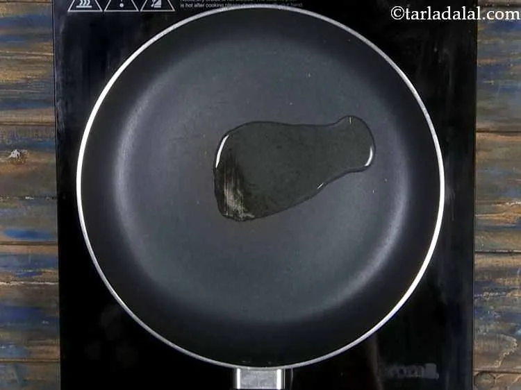 Step 8 – Heat the oil in a broad non-stick pan.