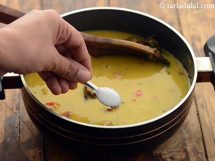 Step 21 – Add a little salt. We have already added salt while boiling the dal so, be …