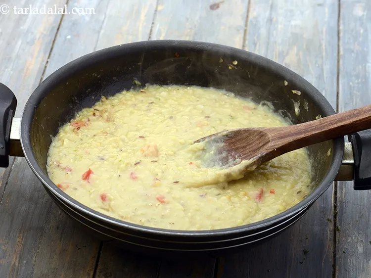 Step 22 – Add the cooked masoor dal and cook on a medium flame for 1 minute.