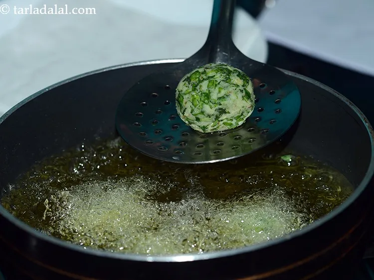 Step 30 – To deep-fry, palak kofta, heat the oil in a kadhai and drop in the koftas, …