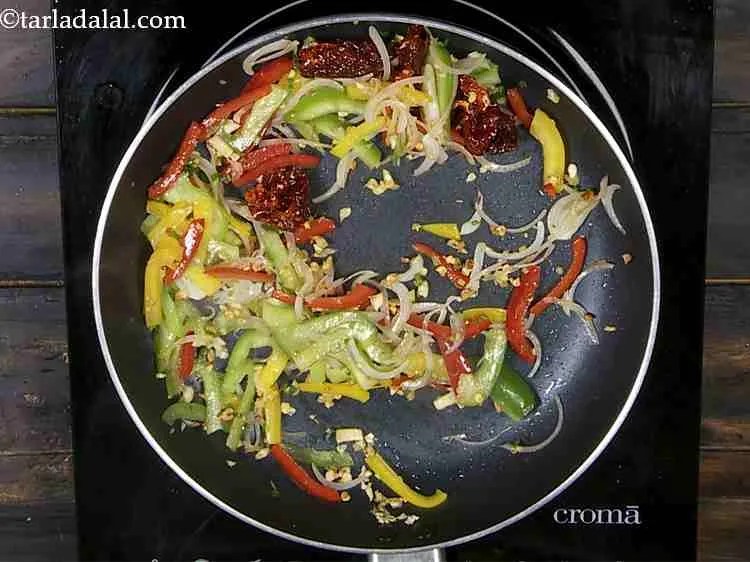 Step 14 – Add the capsicum and saut? on a medium flame for 1 minute.