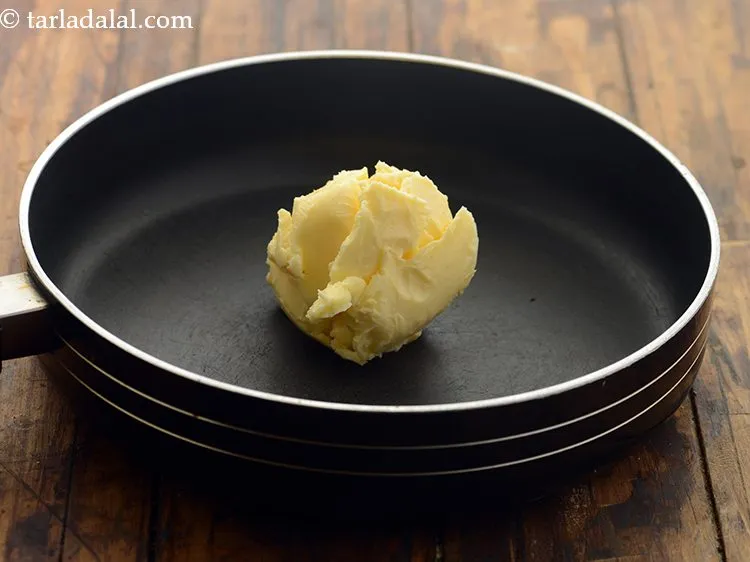Step 7 – Next to make <strong>carrot cake for babies</strong>, add butter in a broad non-stick pan.&nbsp;