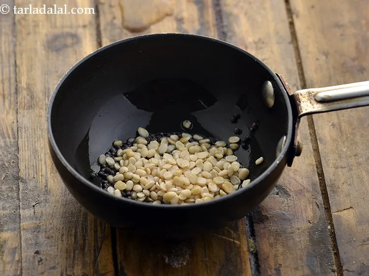Step 19 – When the seeds crackle, add the urad dal.