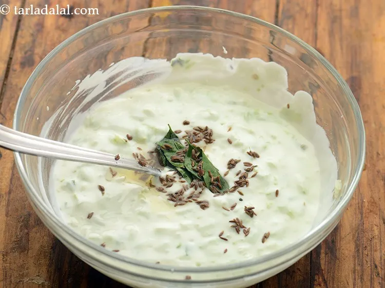 Step 18 – Pour the prepared tempering to the curd cucumber mixture.