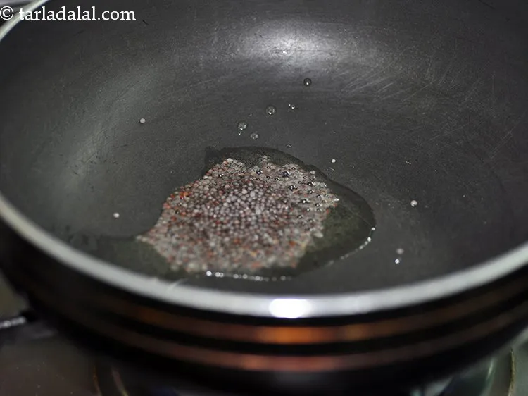 Step 22 – When the oil is hot, add mustard seeds.