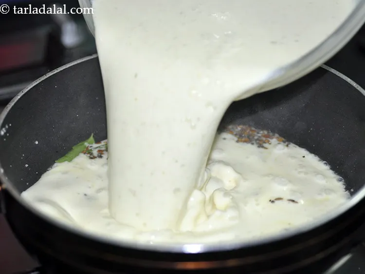 Step 27 – Lower the flame, add the curds-besan mixture. If the flame is high, our curd might …