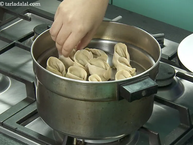 Step 19 – <p>Place the <strong>healthy momos</strong> in the steamer plate. Maintain some distance between them so they …