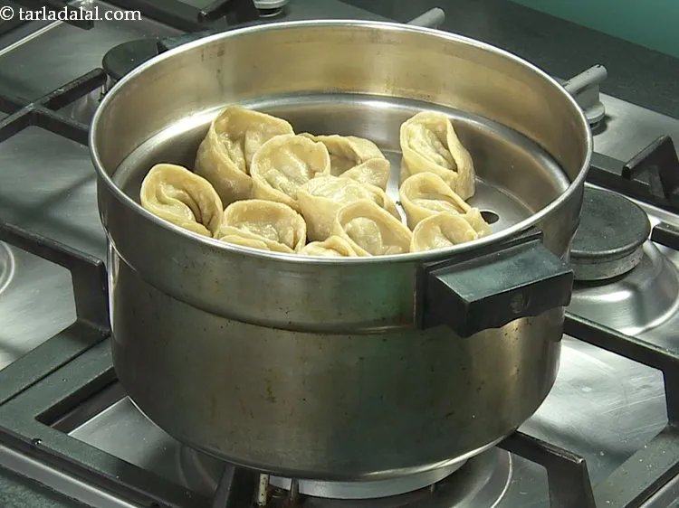 Step 20 – <p>Steam the <strong>veg wheat momos</strong> in a steamer for 10 minutes. Do not overcook the …