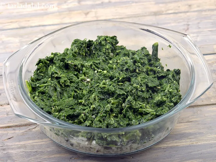 Step 67 – Then put the spinach layer and spread it evenly with the help of a spoon. …