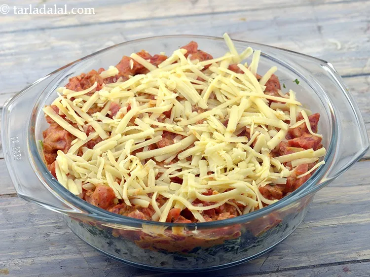 Step 69 – Finally sprinkle 4 tbsp&nbsp;<a href="https://www.tarladalal.com/glossary-grated-processed-cheese-868i">grated processed cheese</a>&nbsp;evenly over it.