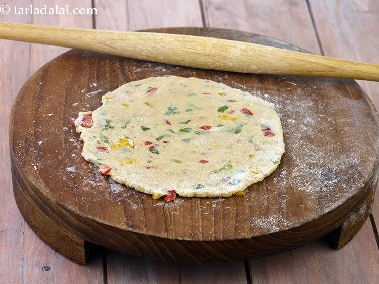 Step 37 – Roll a portion of the dough into a 150 mm. (6&rdquo;) diameter circle using a …