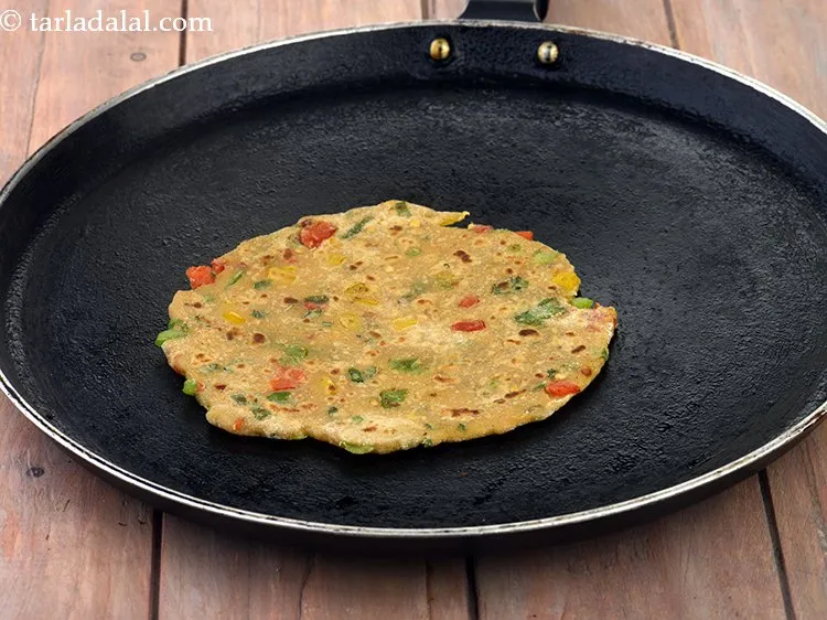 Step 38 – Heat a non-stick tava (griddle) and cook the paratha using &frac14; tsp of <a href="https://www.tarladalal.com/glossary-oil-671i">oil</a>&nbsp;till …