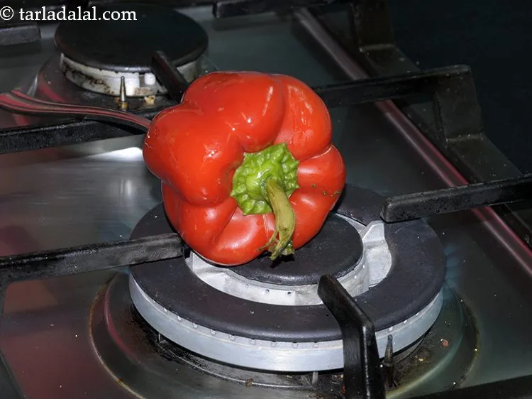 Step 4 – Place the capsicum on an open flame and roast it on a medium flame