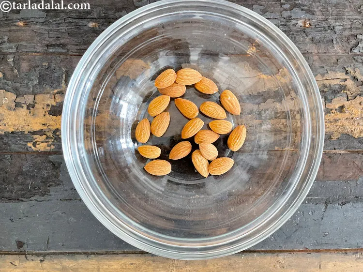 Step 6 – In a deep glass bowl put&nbsp;<meta charset="UTF-8" />20&nbsp;<a href="glossary-almonds-badam-378i">almonds (badam)</a>.