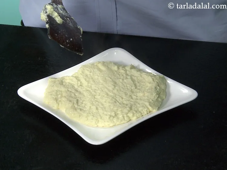 Step 13 – Switch off the flame and transfer the mixture into a flat plate. Keep aside to …