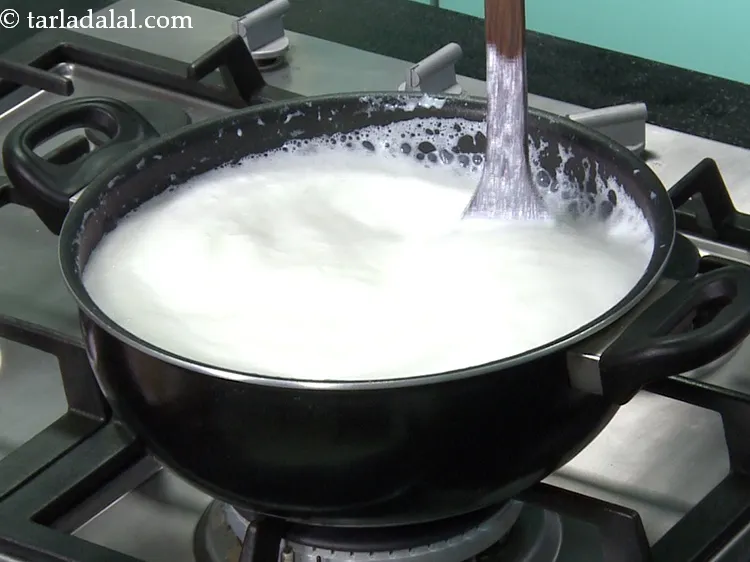 Step 5 – When the milk comes to boil, reduce the flame to medium.
