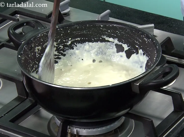 Step 8 – This is milk after another 10 minutes of cooking. It has reduced to &frac34; quantity …