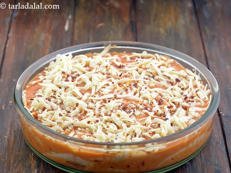 Step 79 – Also sprinkle /2 tsp&nbsp;<a href="https://www.tarladalal.com/glossary-dry-red-chilli-flakes-paprika-338i">dry red chilli flakes (paprika)</a> evenly over it.