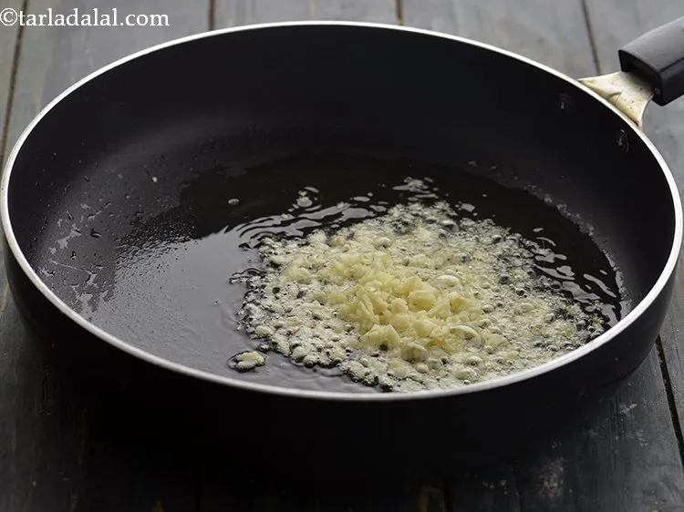 Step 26 – Add 2 tsp&nbsp;finely&nbsp;<a href="https://www.tarladalal.com/glossary-chopped-garlic-790i">chopped garlic (lehsun)</a>.