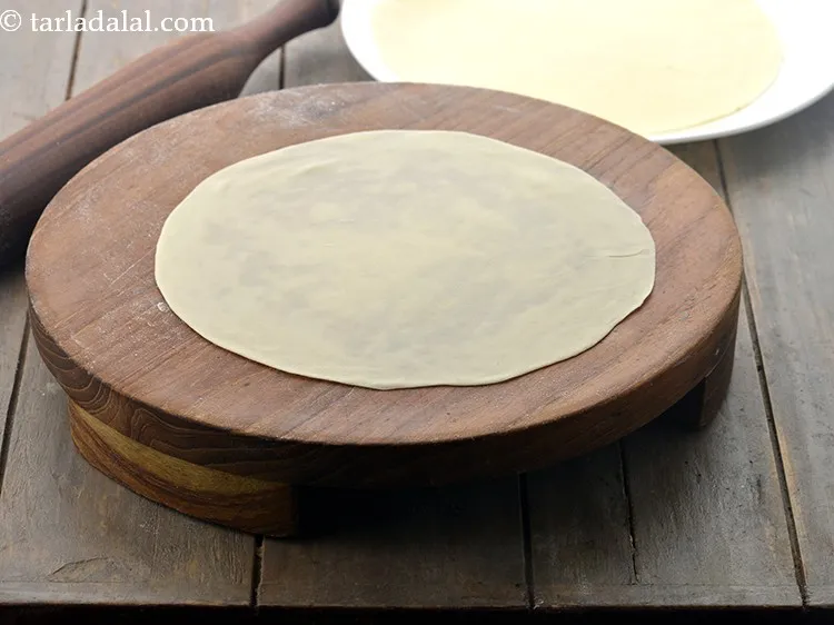 Step 8 – Roll a portion of the dough of <strong>homemade samosa sheet</strong> into a 175mm. (7&rdquo;) diameter …